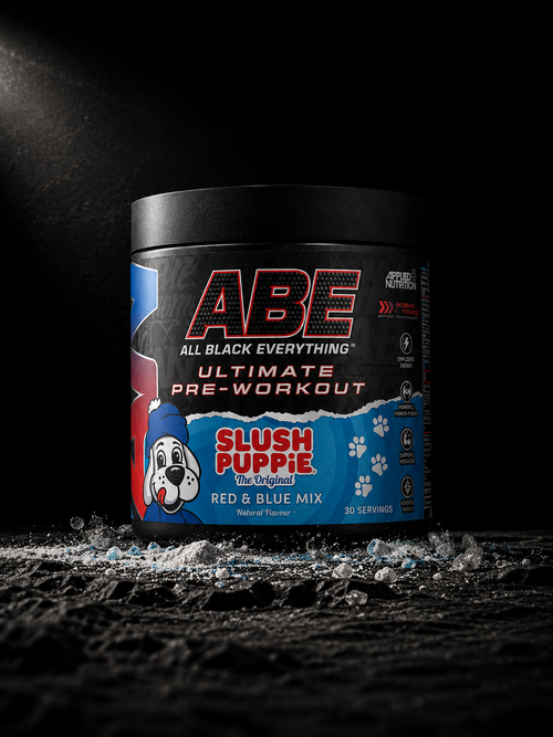 Applied Nutrition ABE Slush Puppie pre-workout tub photographed on dark volcanic stone with scattered pre-workout powder and crystalline ingredient textures in cinematic studio lighting.